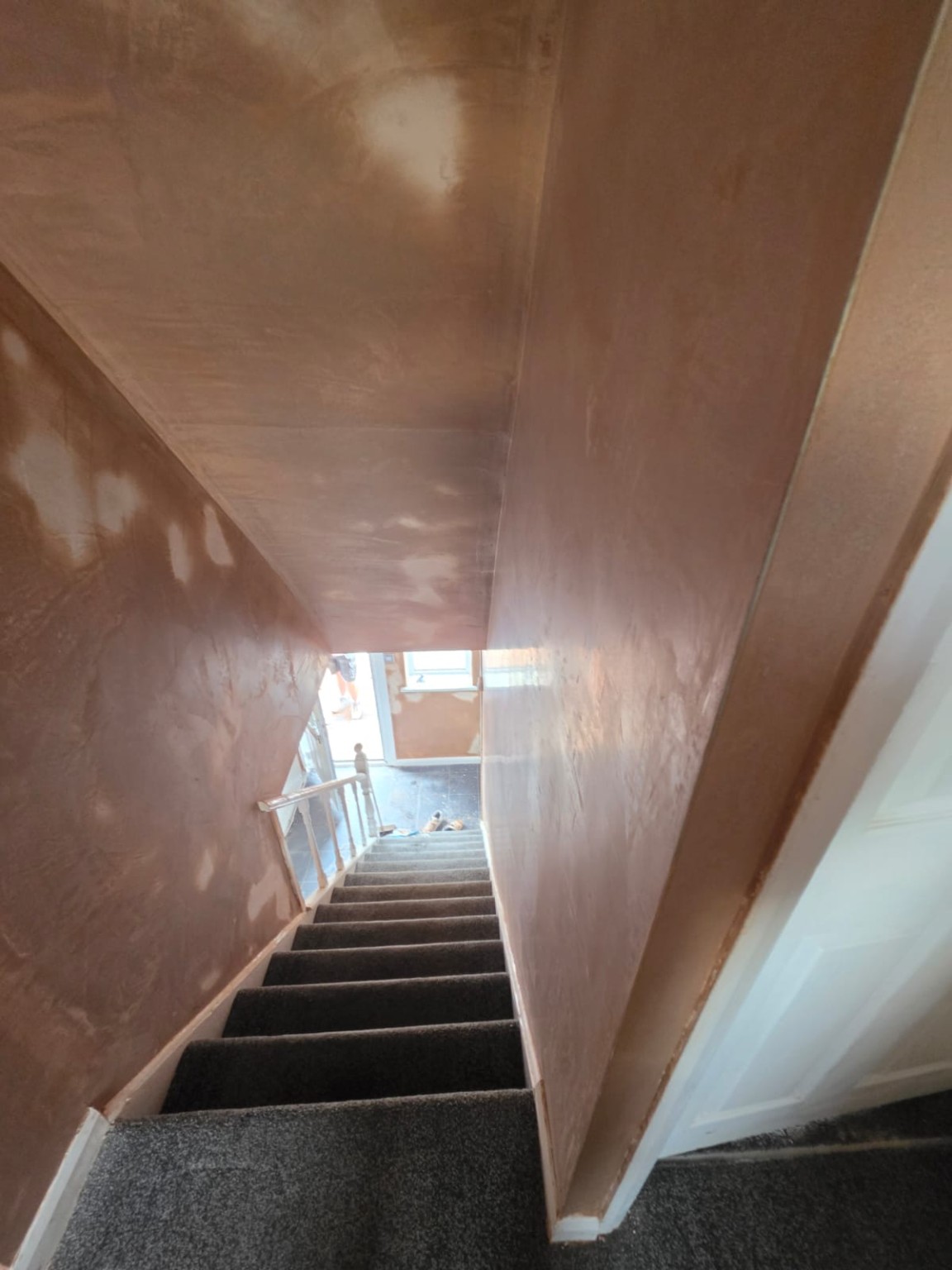 Freshly plastered staircase walls and sloping ceiling